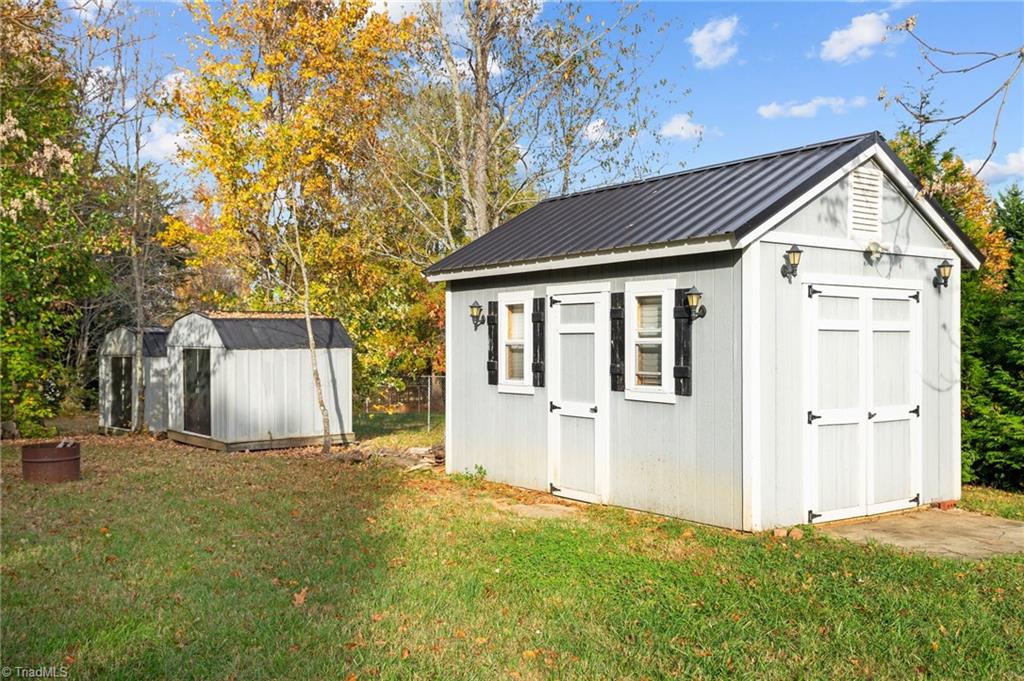 8440 West Harrell Road Oak Ridge, NC 27310 - Photo 6 of 50 Three storage buildings, one has electricity, perfect for She Shed, man cave or workshop