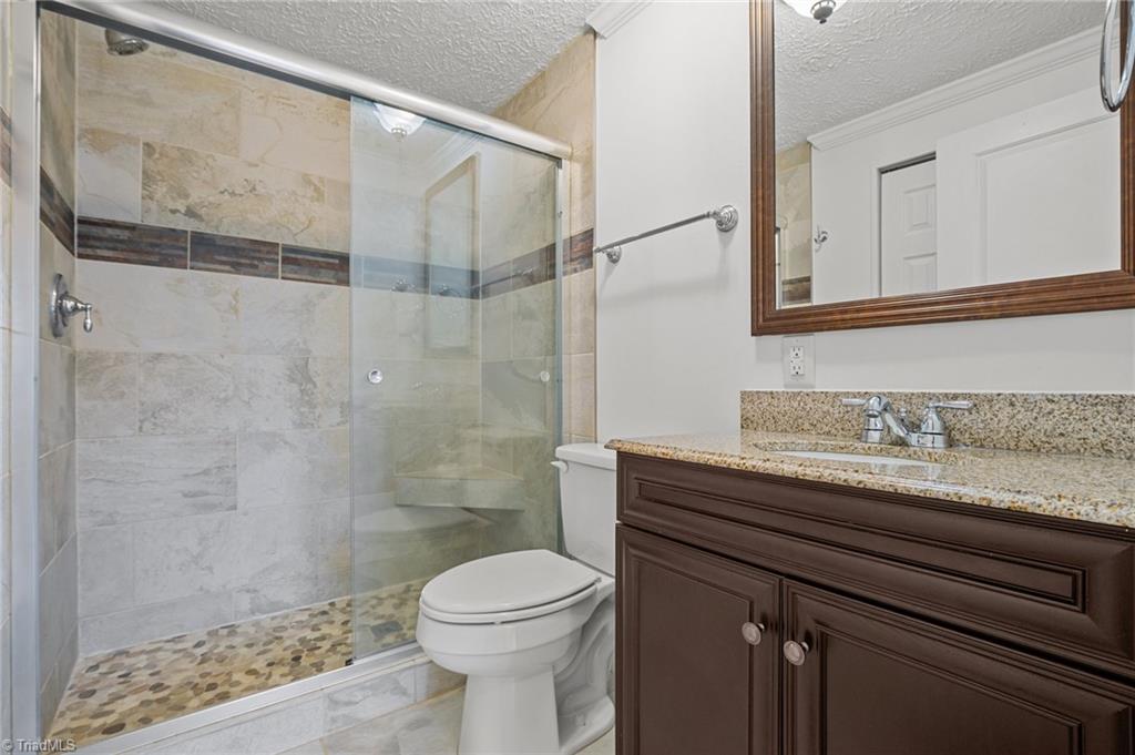 8440 West Harrell Road Oak Ridge, NC 27310 - Photo 10 of 50 Tile shower, newer vanity, hall bathroom