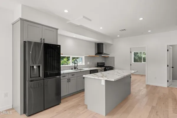 a kitchen with refrigerator a sink and cabinets