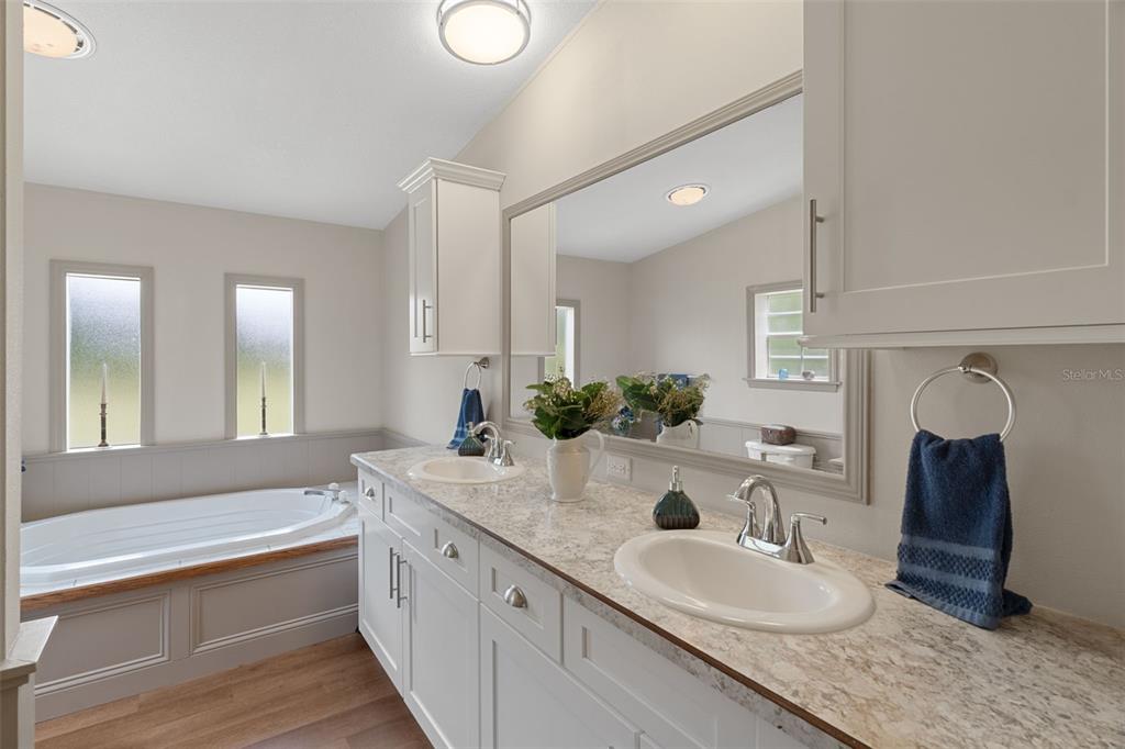 26255 Lambeth Road Brooksville, FL 34601 - Photo 42 of 76 a bathroom with a granite countertop double vanity sink and a mirror