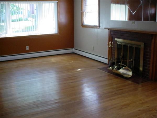 28 Whittaker Street Springfield, MA 01104 - Photo 2 of 6 an empty room with wooden floor and windows