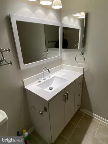 a bathroom with a sink double vanity and a mirror