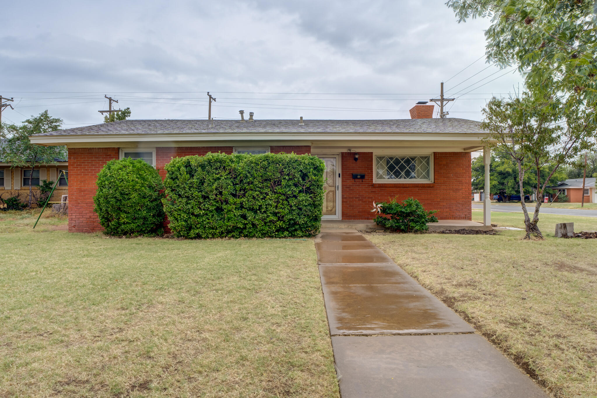 5502 8th Street Lubbock, TX 79416 - Photo 1 of 37 a front view of a house with garden