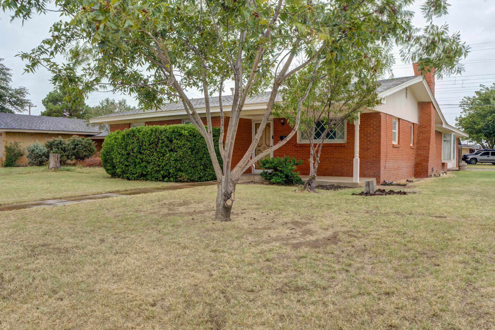 5502 8th Street Lubbock, TX 79416 - Photo 2 of 37 a view of a house with a yard and garage