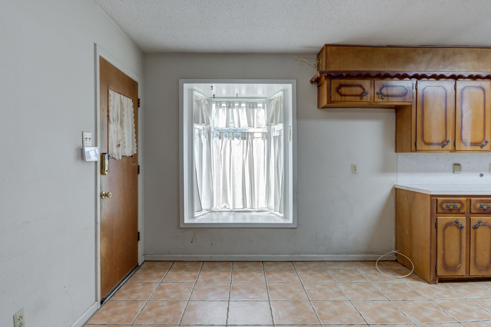 5502 8th Street Lubbock, TX 79416 - Photo 21 of 37 a view of an empty room with window and hardwood floor