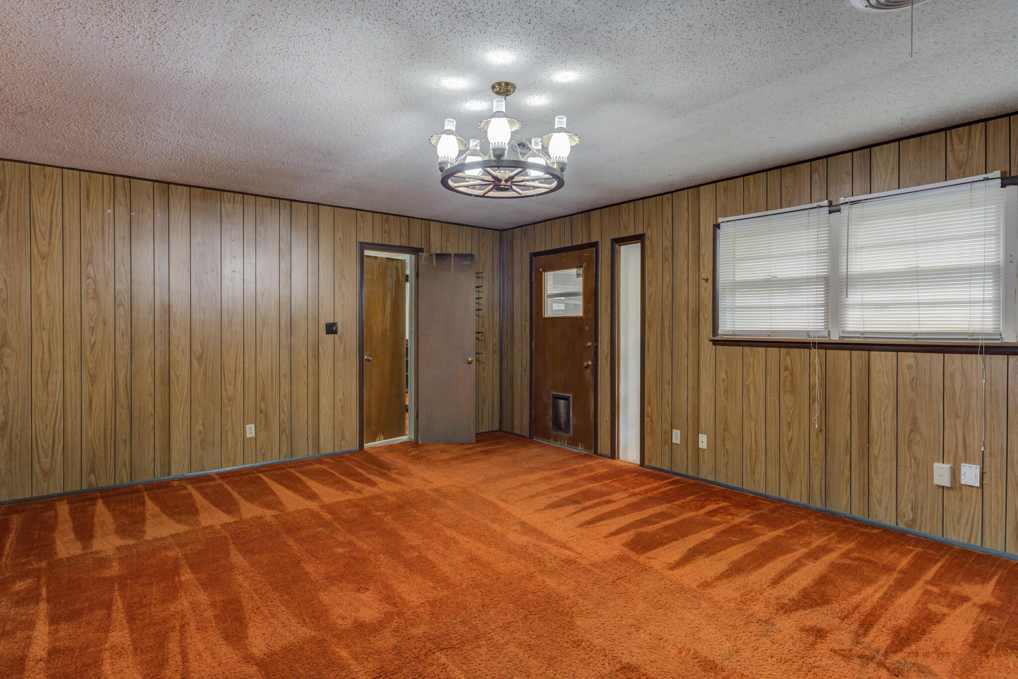 5502 8th Street Lubbock, TX 79416 - Photo 22 of 37 a bedroom with a large bed and a chandelier