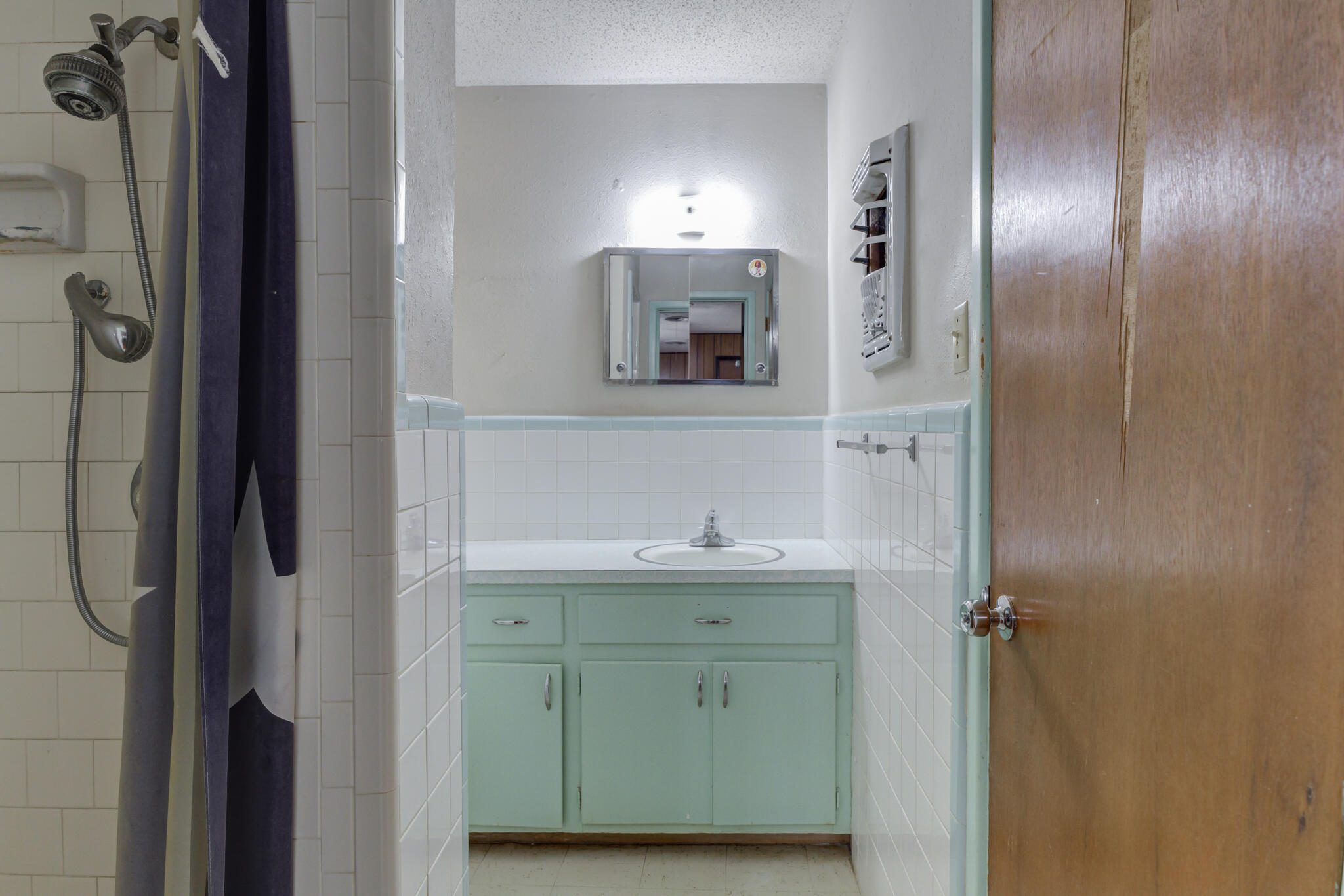5502 8th Street Lubbock, TX 79416 - Photo 24 of 37 a bathroom with a sink and a mirror
