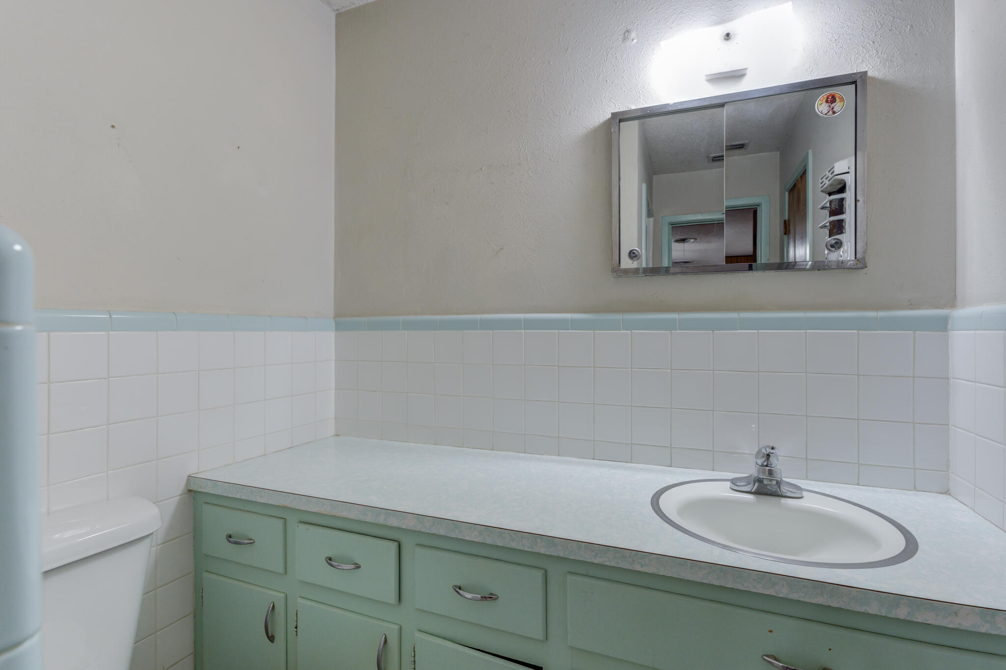 5502 8th Street Lubbock, TX 79416 - Photo 25 of 37 a bathroom with a sink and a mirror