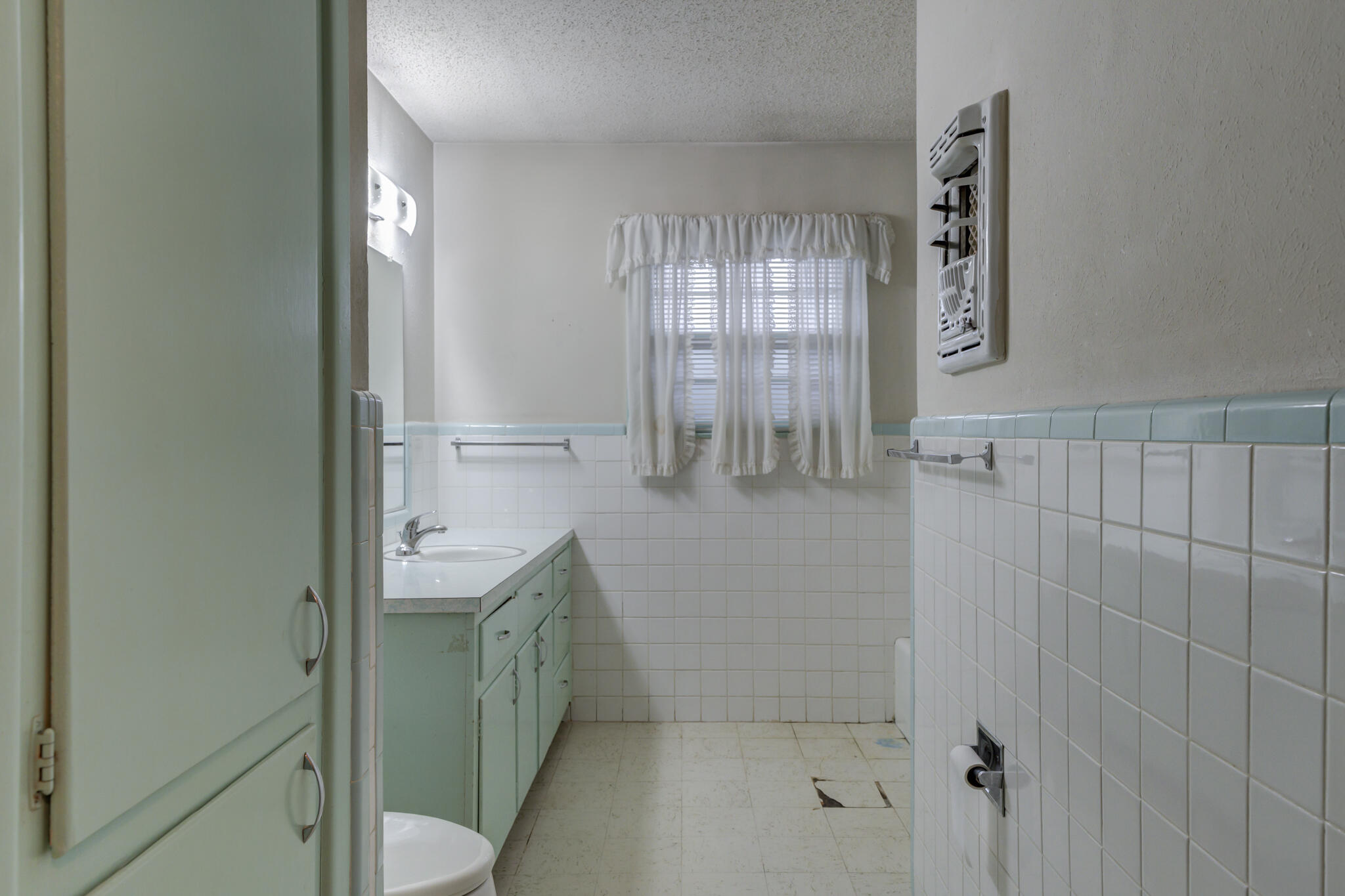 5502 8th Street Lubbock, TX 79416 - Photo 30 of 37 a bathroom with a granite countertop sink a toilet and shower