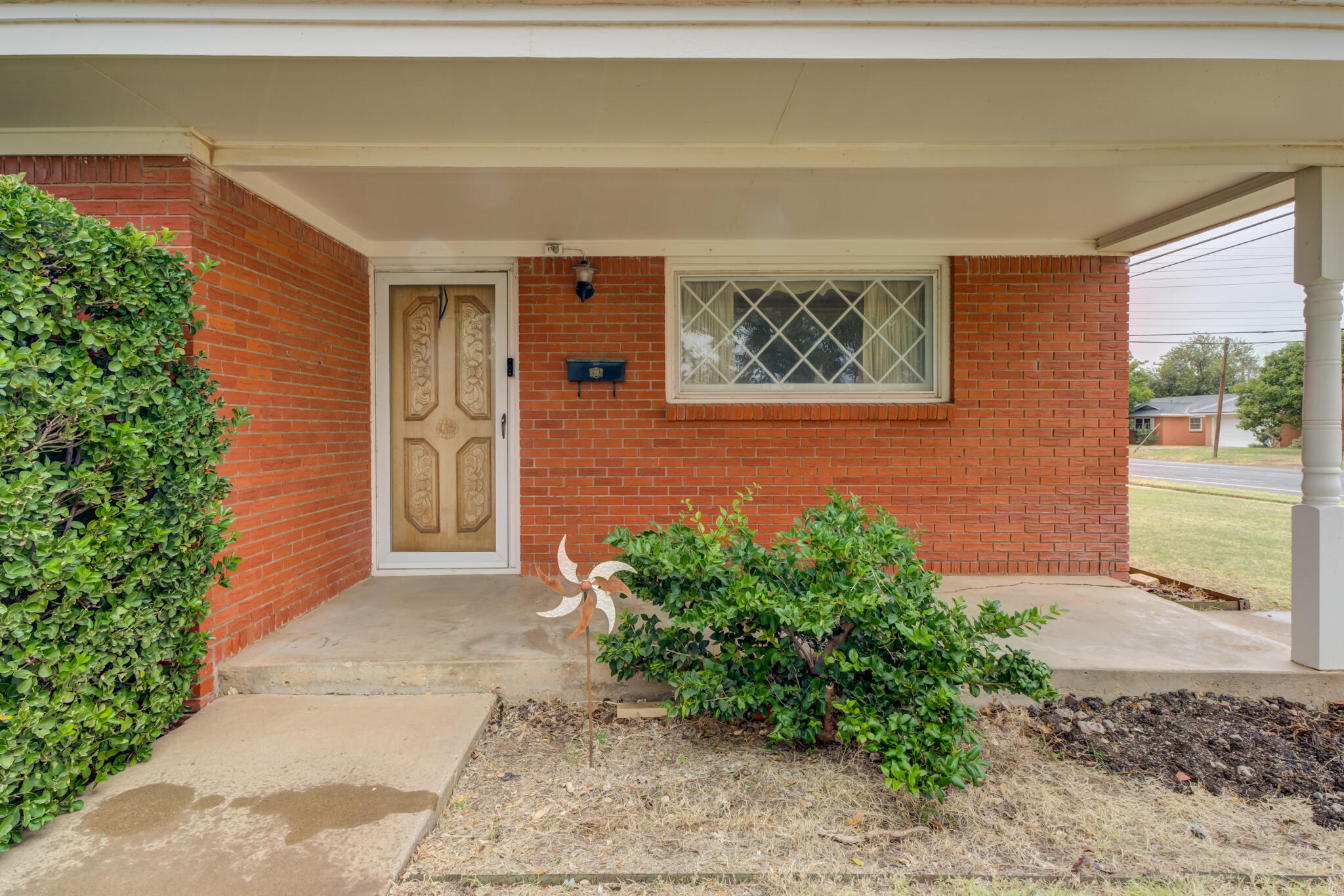 5502 8th Street Lubbock, TX 79416 - Photo 3 of 37 a front view of a house with garden