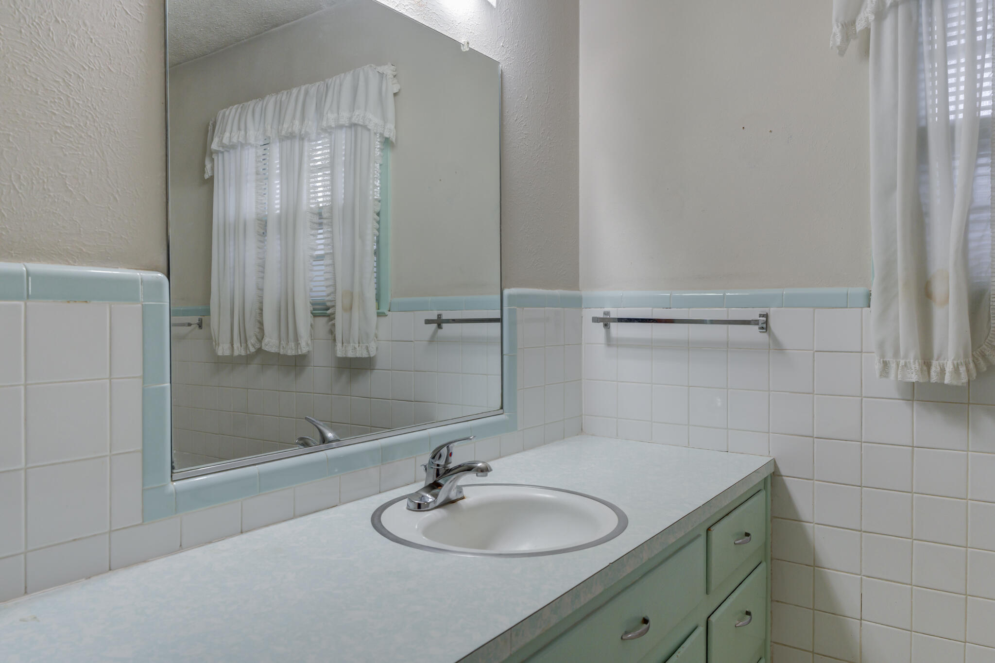 5502 8th Street Lubbock, TX 79416 - Photo 31 of 37 a bathroom with a sink and a mirror