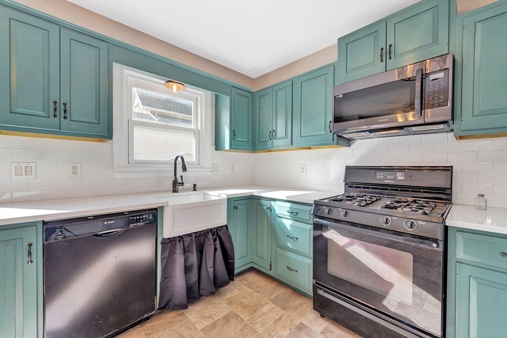 7 Harold Avenue Gloucester, MA 01930 - Photo 17 of 42 a kitchen with a sink stove and microwave