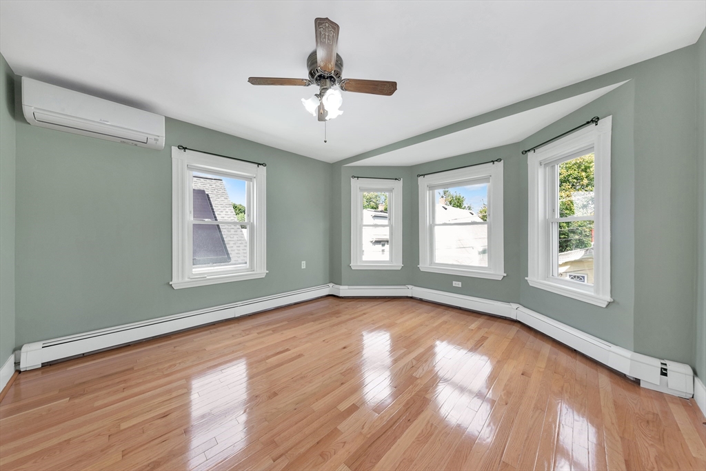 7 Harold Avenue Gloucester, MA 01930 - Photo 35 of 42 a view of an empty room with wooden floor and a window