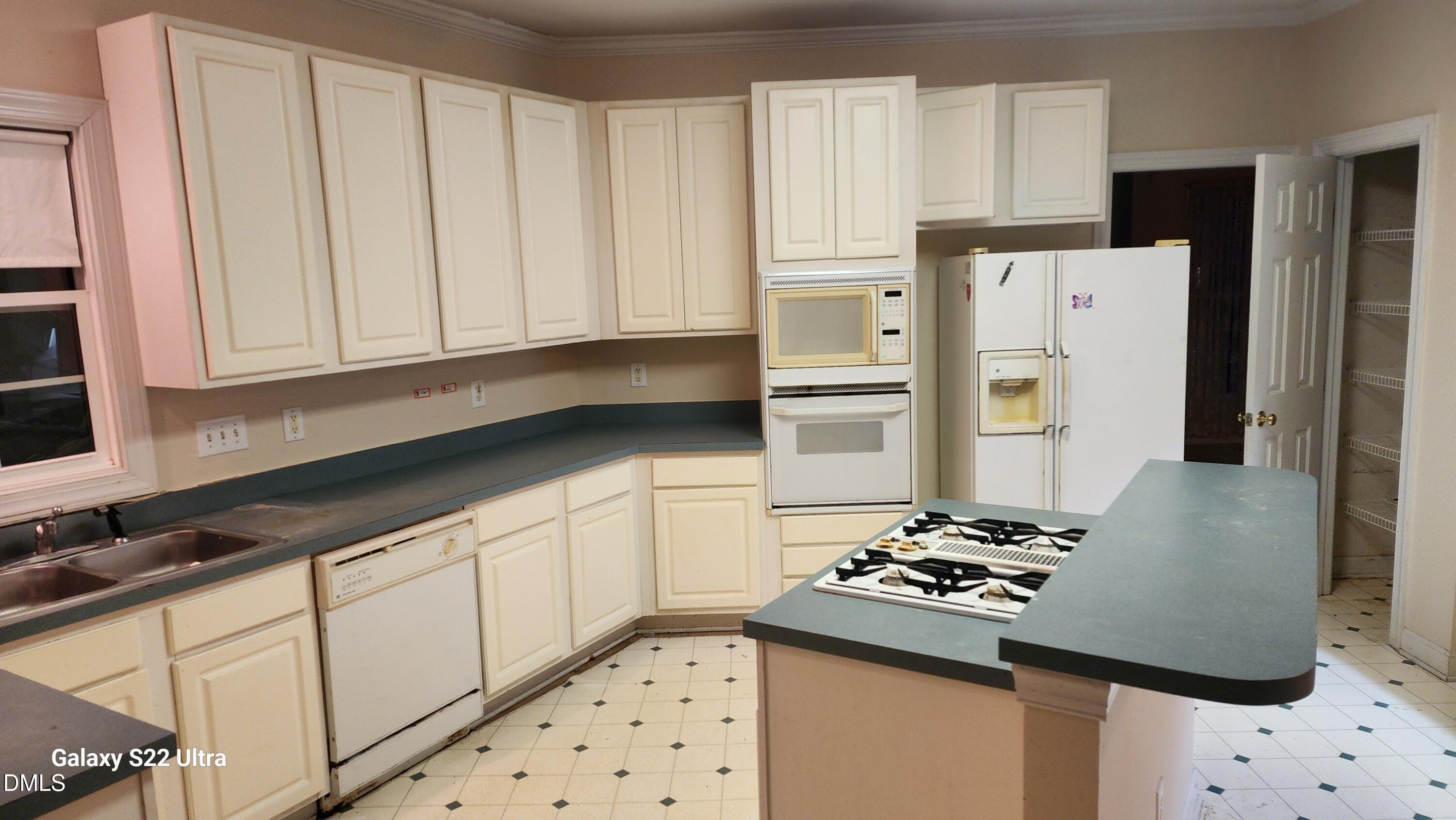 1 Haycox Court Durham, NC 27713 - Photo 49 of 91 a kitchen with granite countertop a refrigerator sink and stove