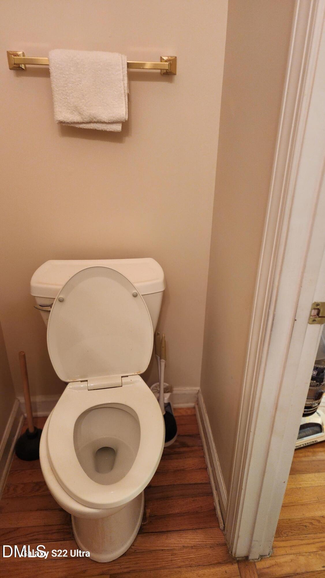 1 Haycox Court Durham, NC 27713 - Photo 55 of 91 a toilet sitting in a bathroom next to a wooden floor