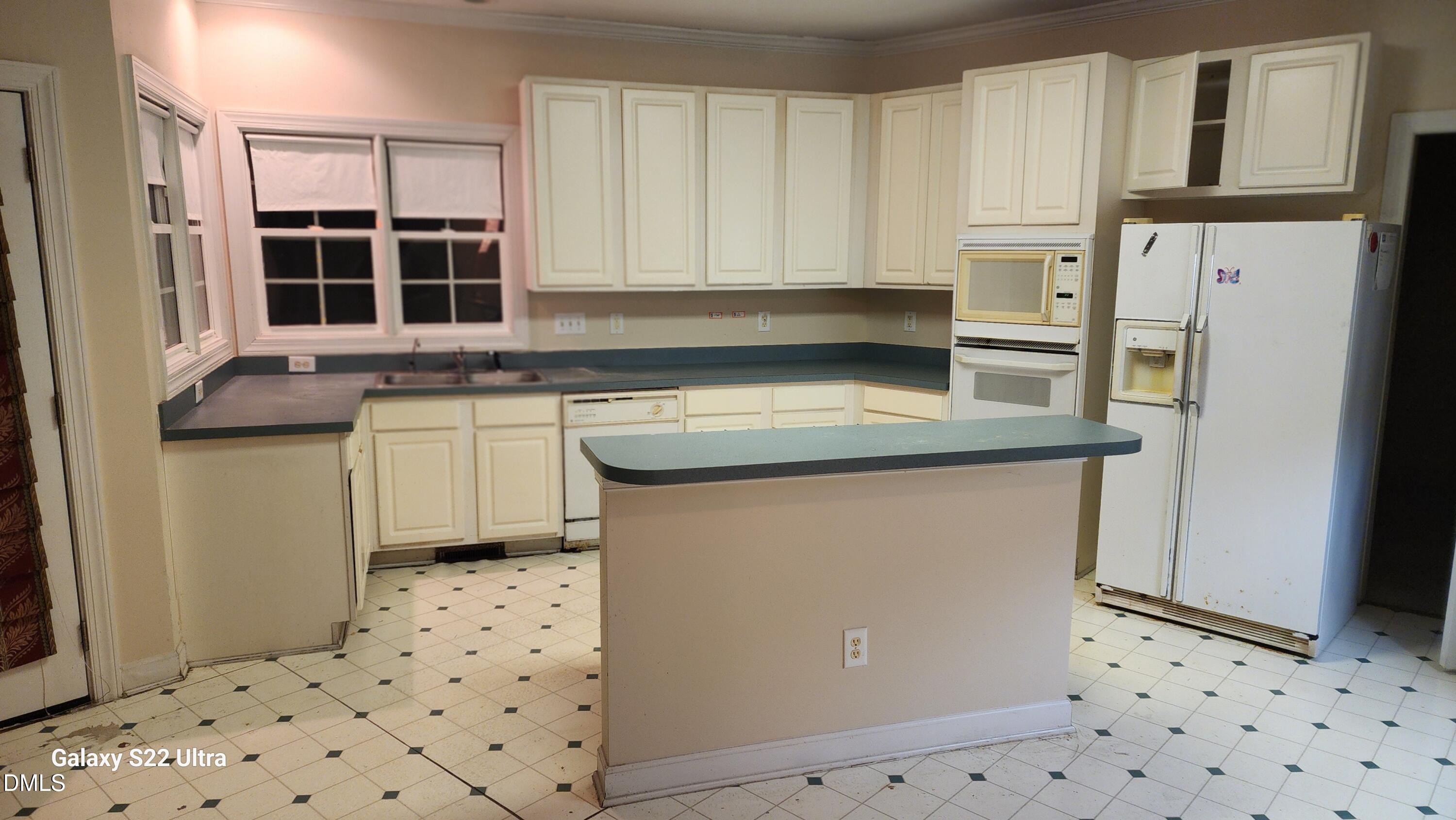 1 Haycox Court Durham, NC 27713 - Photo 82 of 91 a kitchen with stainless steel appliances granite countertop a refrigerator a sink a stove and white cabinets