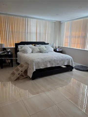 a spacious bedroom with a bed and a couch