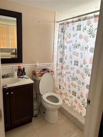 a bathroom with a sink toilet and mirror