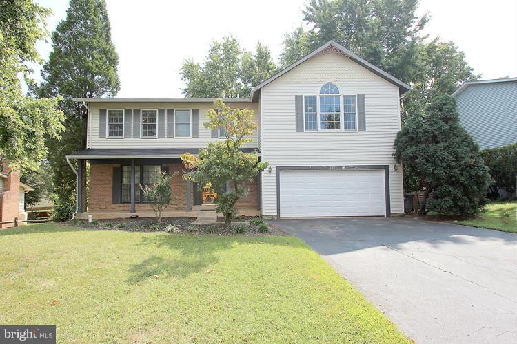 8955 Rolling Road Manassas, VA 20110 - Photo 1 of 30 a front view of a house with a yard and garage