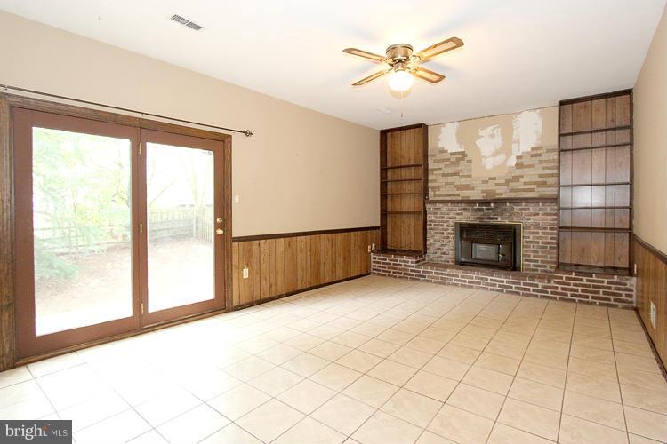 8955 Rolling Road Manassas, VA 20110 - Photo 11 of 30 a view of an empty room with a fireplace and a window