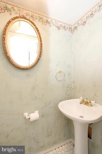 8955 Rolling Road Manassas, VA 20110 - Photo 13 of 30 a bathroom with a sink a vanity and a mirror