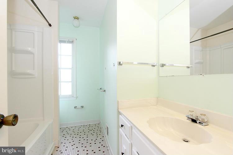 8955 Rolling Road Manassas, VA 20110 - Photo 15 of 30 a bathroom with a sink a mirror and a shower