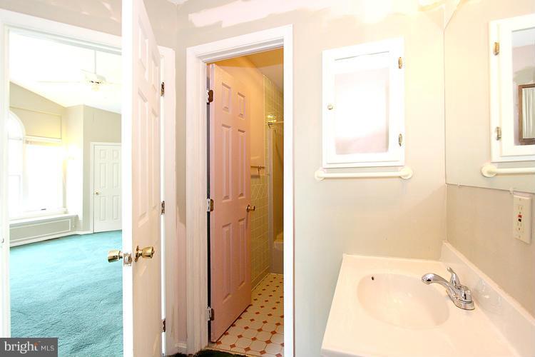 8955 Rolling Road Manassas, VA 20110 - Photo 20 of 30 a bathroom with a tub shower and a sink
