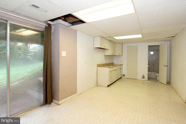 8955 Rolling Road Manassas, VA 20110 - Photo 25 of 30 a view of a kitchen with a cabinet and a refrigerator