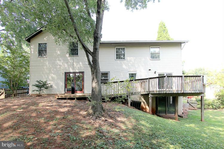 8955 Rolling Road Manassas, VA 20110 - Photo 30 of 30 a view of a house with wooden deck and furniture