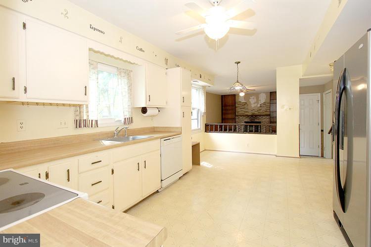8955 Rolling Road Manassas, VA 20110 - Photo 8 of 30 a large white kitchen with a large window