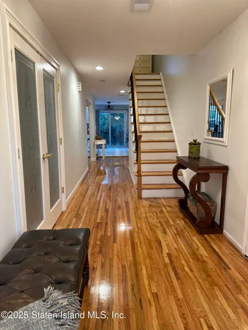 a view of a living room and kitchen with a wooden floor