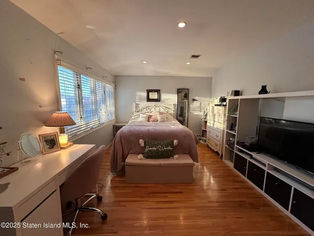 a bed room with furniture and a flat screen tv