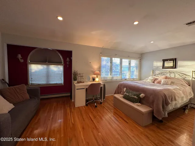 a spacious bedroom with a bed and large windows