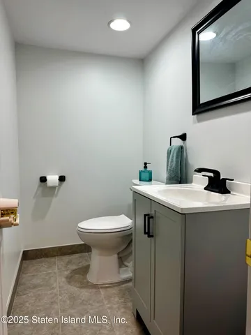 a bathroom with a sink a toilet and mirror