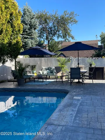 a view of a patio with furniture and a yard