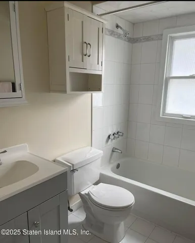 a white toilet sitting next to a bathroom sink