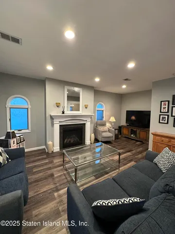 a living room with furniture a fireplace and a flat screen tv