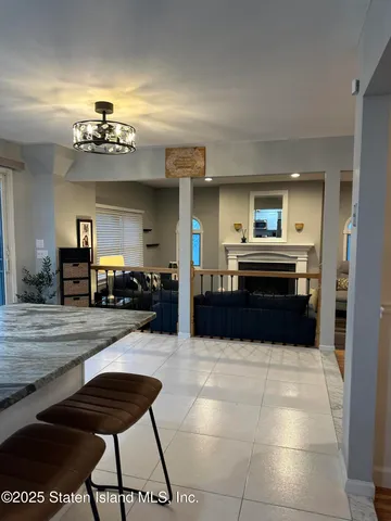 a kitchen with kitchen island granite countertop a refrigerator and a stove top oven