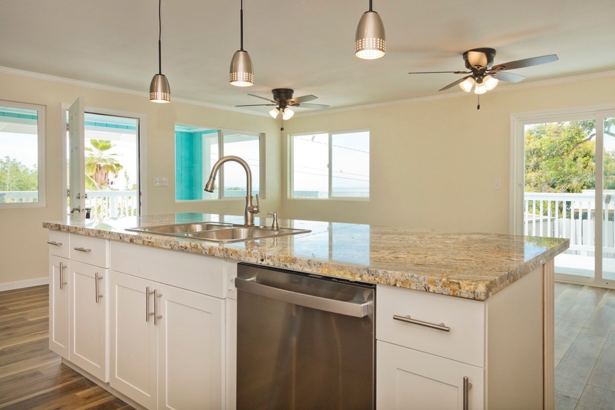 a kitchen with granite countertop a sink cabinets and window