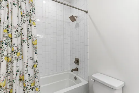 a bathroom with a toilet and shower