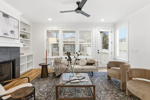 a living room with furniture fireplace and a window