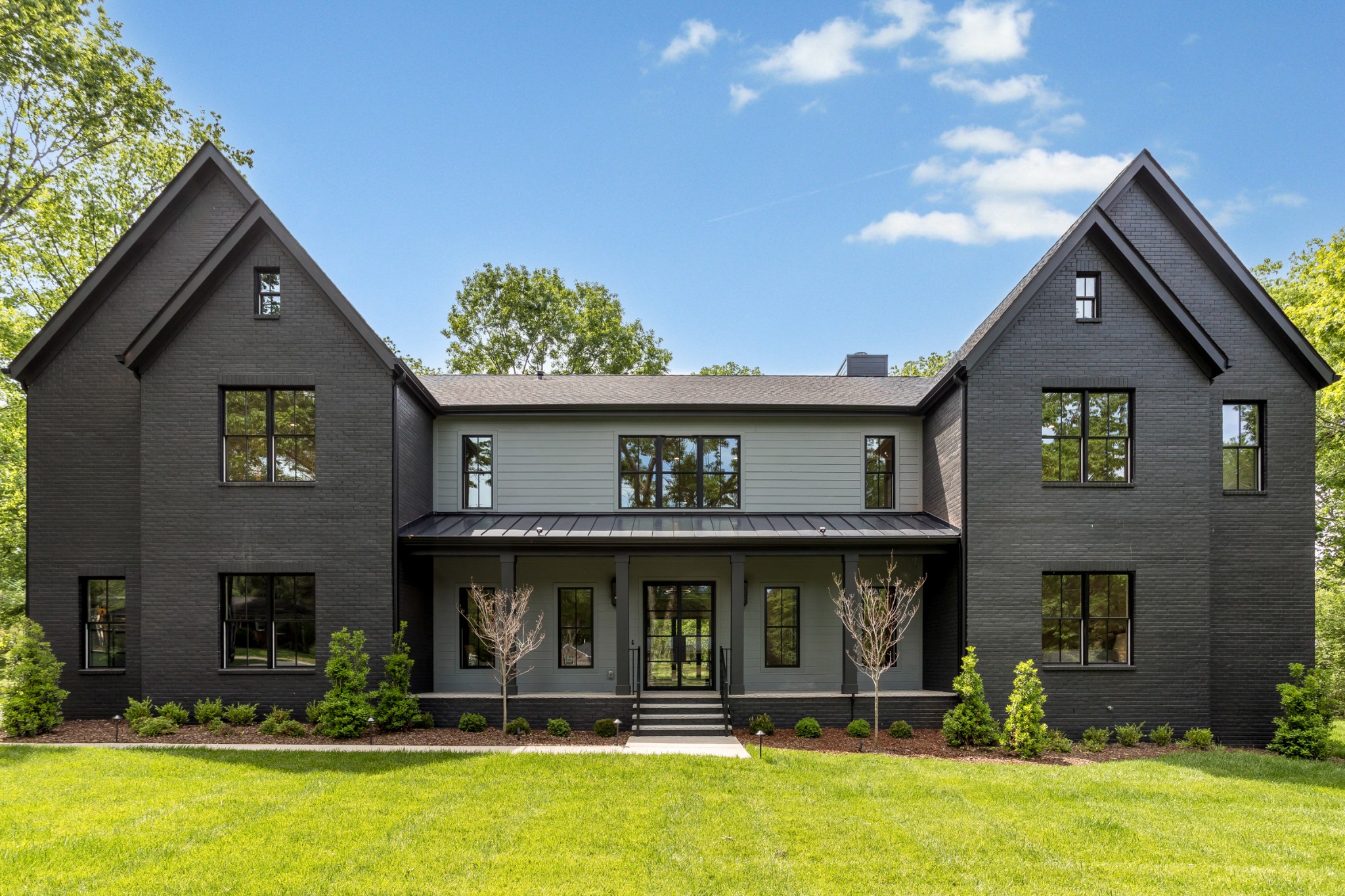 a view of a brick house with windows and yard