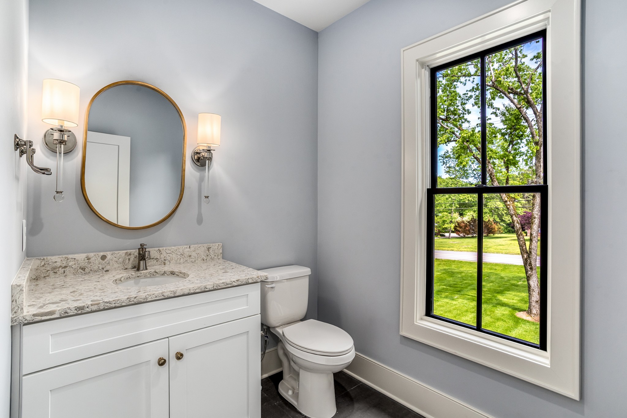 709 Brook Hollow Road Nashville, TN 37205 - Photo 23 of 55 a bathroom with a granite countertop toilet a sink and a mirror