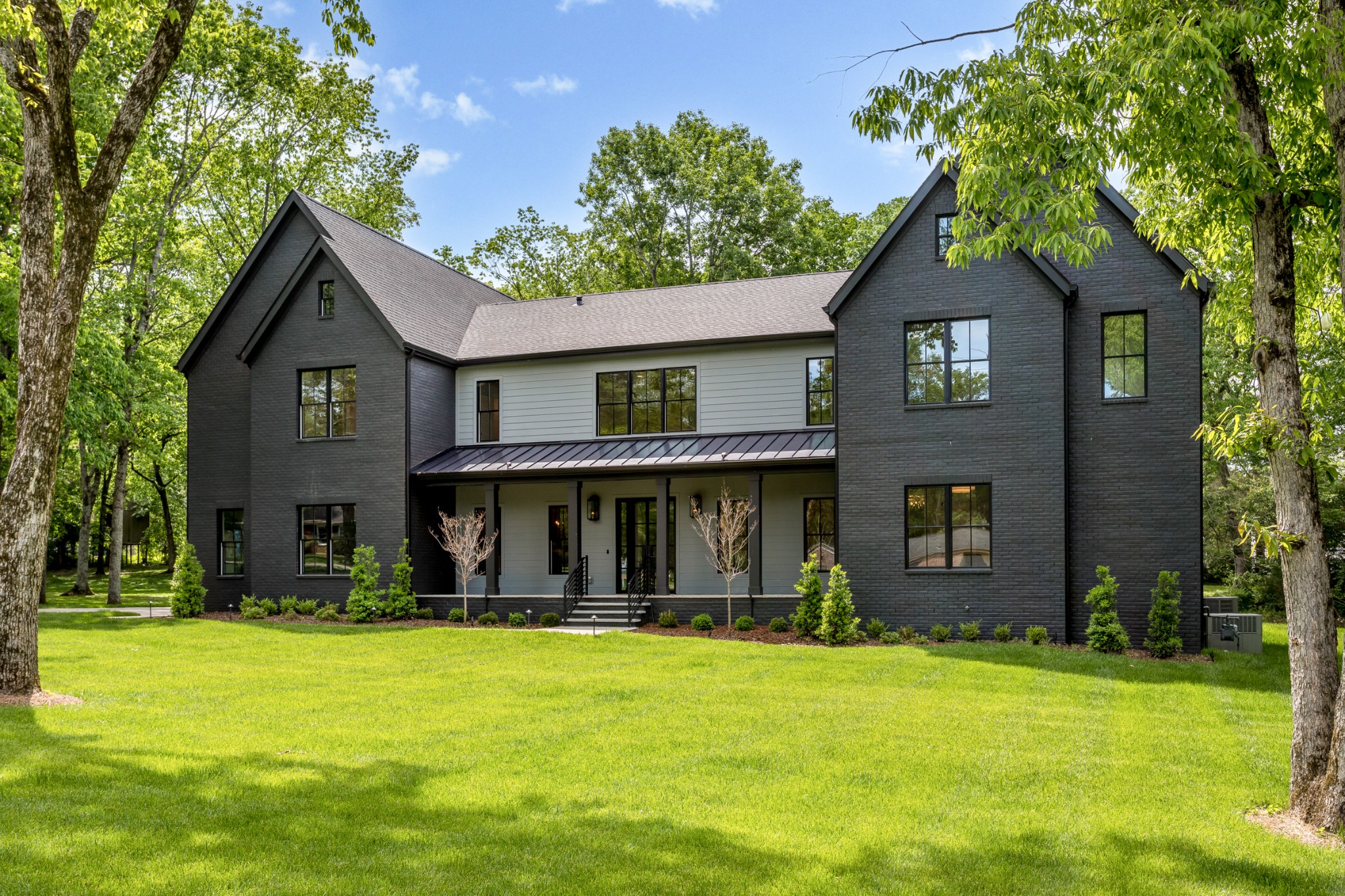 709 Brook Hollow Road Nashville, TN 37205 - Photo 3 of 55 a front view of a house with a yard