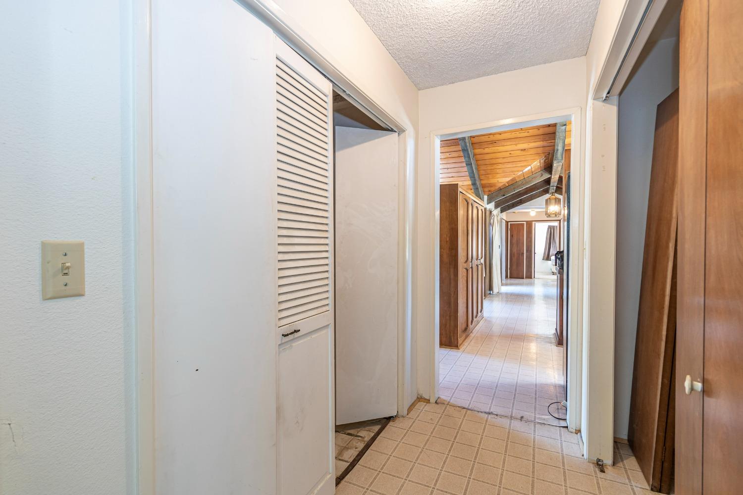 51675 Coyote Rdg Road Oakhurst, CA 93644 - Photo 18 of 41 This hallway houses the laundry set up and a large pantry.