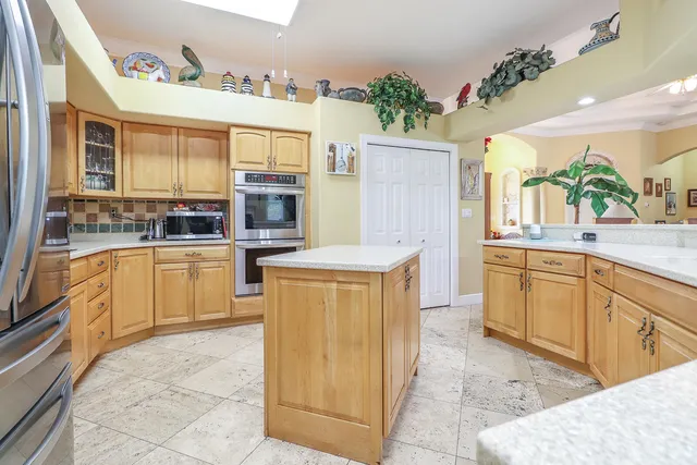 a kitchen with cabinets and window