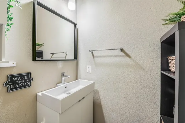 a bathroom with a sink mirror and vanity