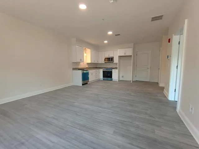 a view of kitchen with microwave and cabinets