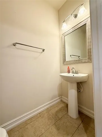 a large white kitchen with stainless steel appliances granite countertop a sink and cabinets