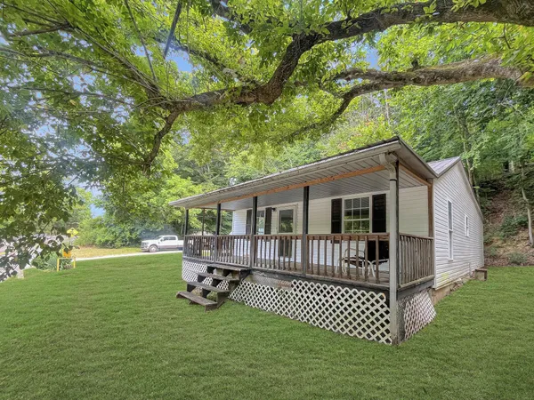 a view of a house with a yard and deck